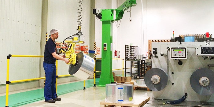 INDEVA Liftronic industrial manipulator lifting a heavy roll in a manufacturing plant